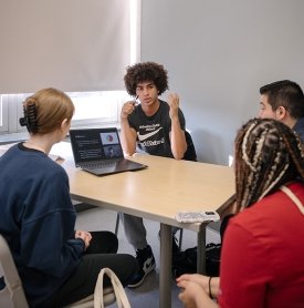 A student presents to his classmates in an English course