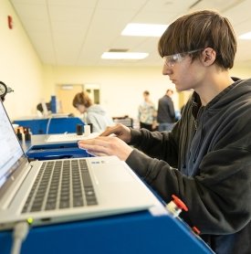 A Mechatronics student works on a computer in the Mechatronics lab