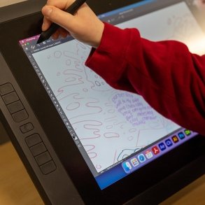 close up of a media arts student using a tablet to illustrate
