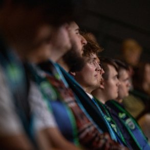 ECCA graduates sit in a row at a ceremony recognizing their achievements