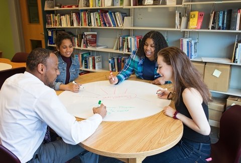 EOP students sitting at a work table writing out concepts