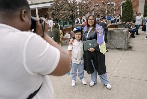 Female EOP graduate standing with youth family member