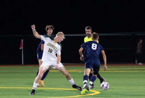 Men's Soccer game on the turf at night