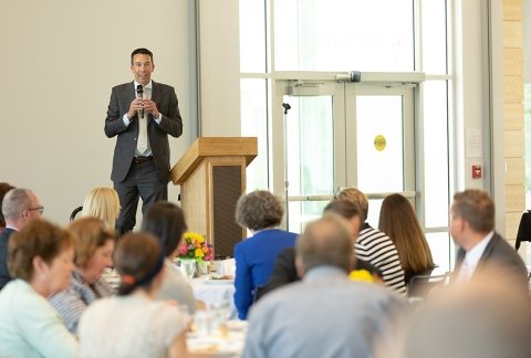 A speaker addressing the crowd at an event hosted in the northwest bay conference center