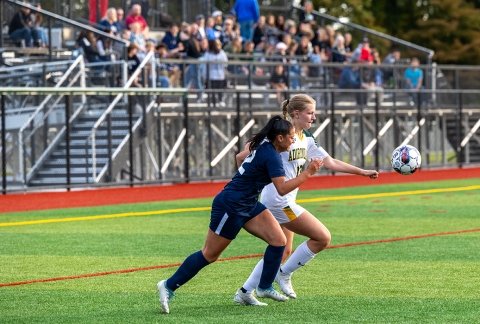 women's soccer with a crowd on the bleechers